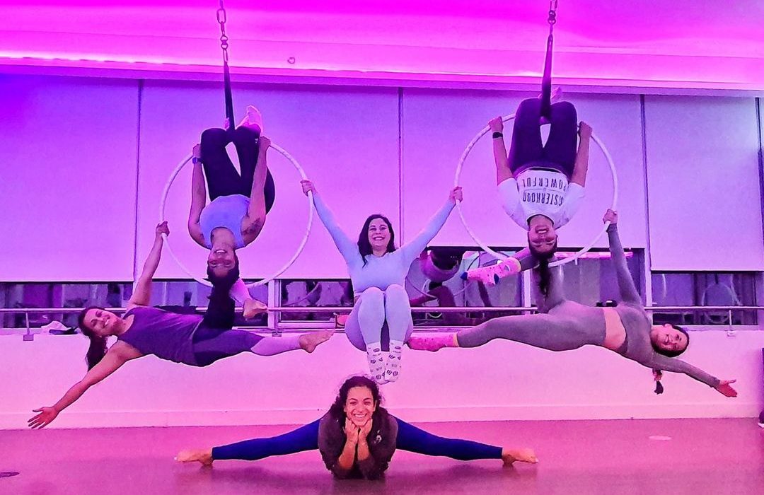 women on hoops at a Aerial Fitness class